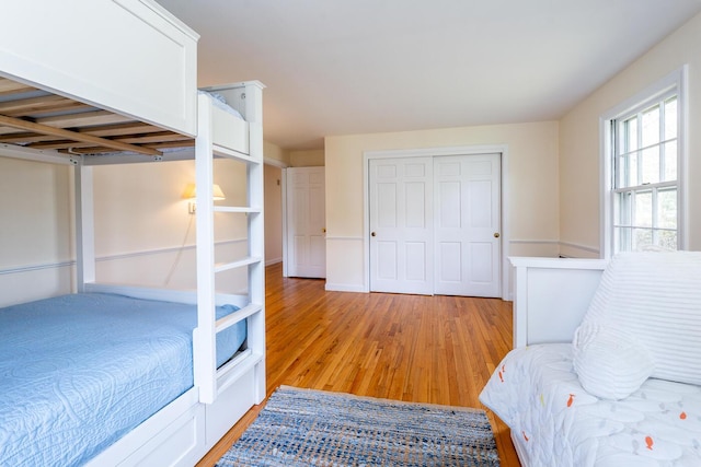 bedroom featuring light wood finished floors and a closet