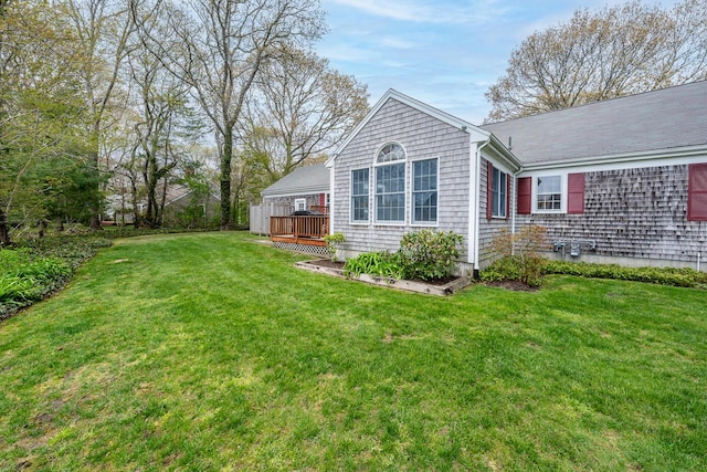 back of house featuring a deck and a yard