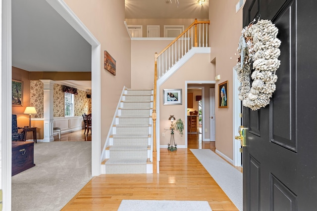 415 Raymond Rd, Plymouth, MA 02360 - foyer with decorative columns, wood finished floors, wainscoting, stairs, and baseboards