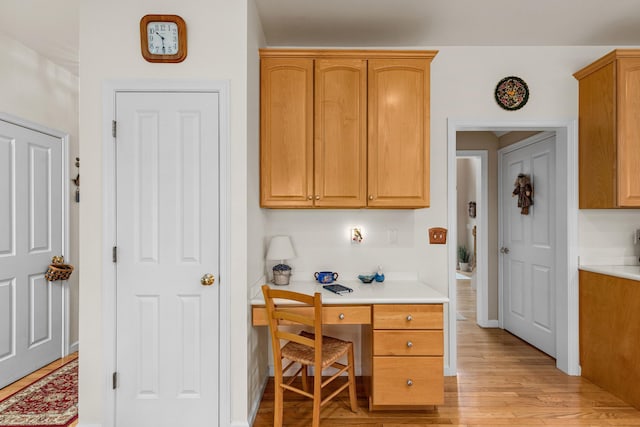 415 Raymond Rd, Plymouth, MA 02360 - kitchen featuring baseboards, built in study area, light wood-type flooring, and light countertops
