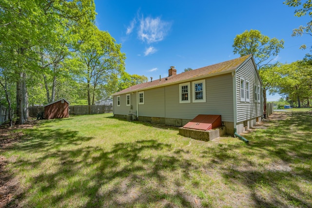 75 Swan Lake Rd, West Yarmouth, MA 02673 - rear view of house with a chimney