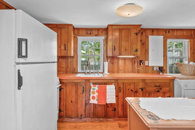 75 Swan Lake Rd, West Yarmouth, MA 02673 - kitchen with white appliances, electric panel, light wood-style floors, a sink, and light countertops