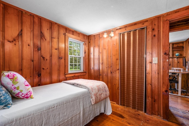 75 Swan Lake Rd, West Yarmouth, MA 02673 - bedroom featuring wood-type flooring and wooden walls