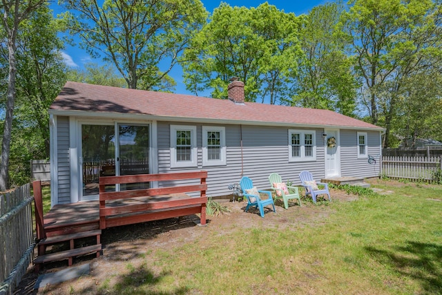 75 Swan Lake Rd, West Yarmouth, MA 02673 - rear view of property with a chimney, a wooden deck, and roof with shingles