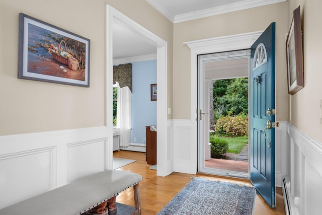 entryway featuring light hardwood / wood-style floors, a wealth of natural light, and ornamental molding