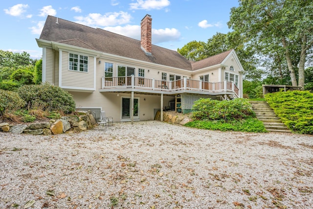 rear view of house featuring a deck