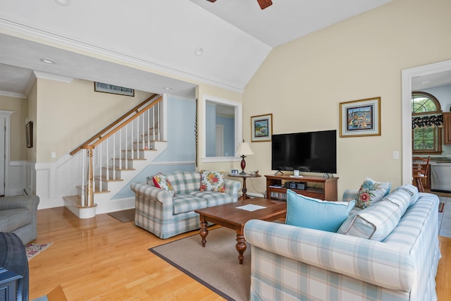 living room featuring crown molding, hardwood / wood-style floors, ceiling fan, and lofted ceiling