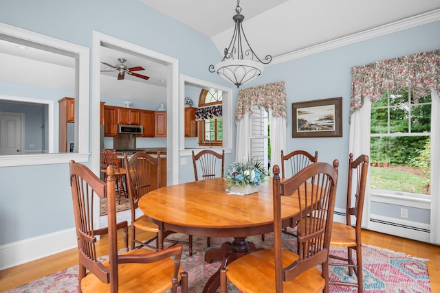 dining space featuring ceiling fan with notable chandelier, lofted ceiling, and light wood-type flooring