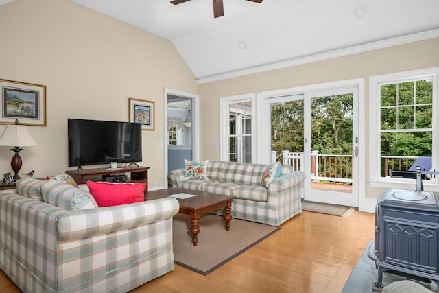 living room featuring ceiling fan, light wood-type flooring, lofted ceiling, and crown molding