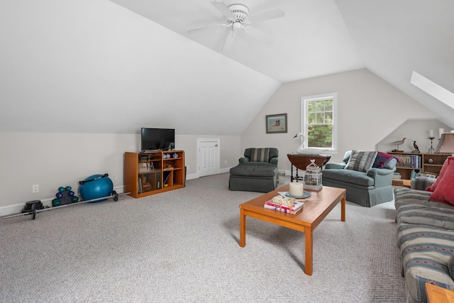 living room with carpet floors, ceiling fan, and lofted ceiling with skylight