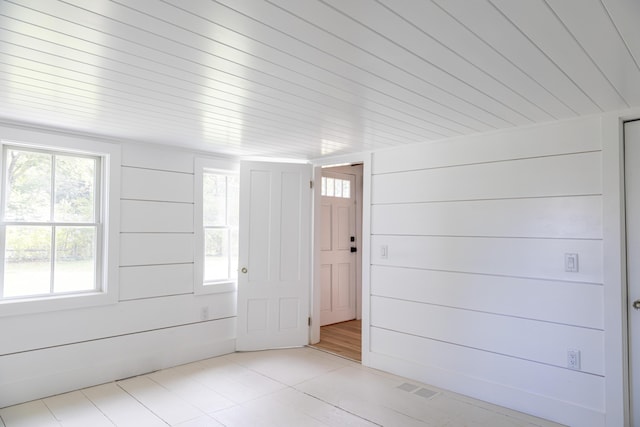 foyer entrance with wooden walls