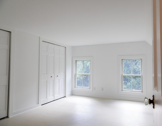 unfurnished bedroom with light wood-type flooring