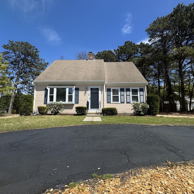 29 Lumberjack Trl, West Yarmouth, MA 02673 - cape cod house featuring a chimney and a front lawn