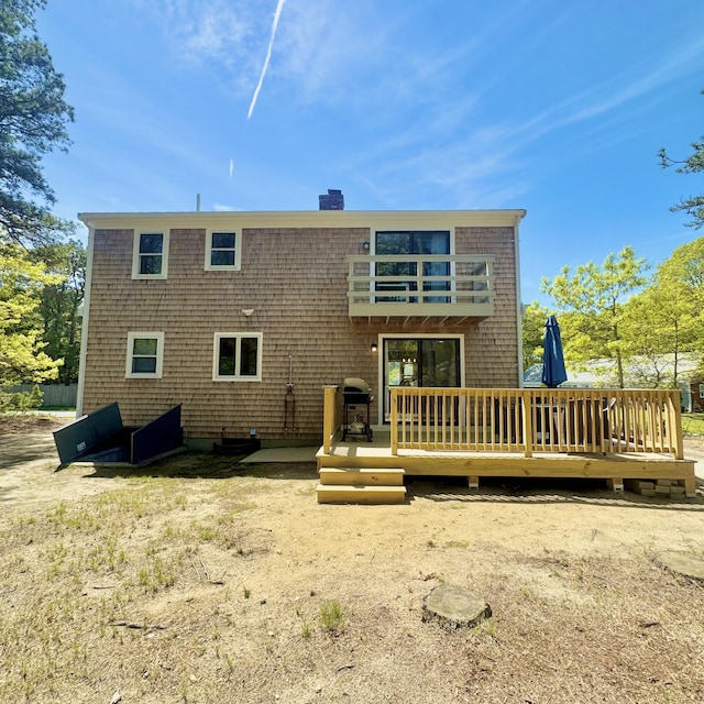 29 Lumberjack Trl, West Yarmouth, MA 02673 - back of property featuring a wooden deck, a chimney, and a balcony