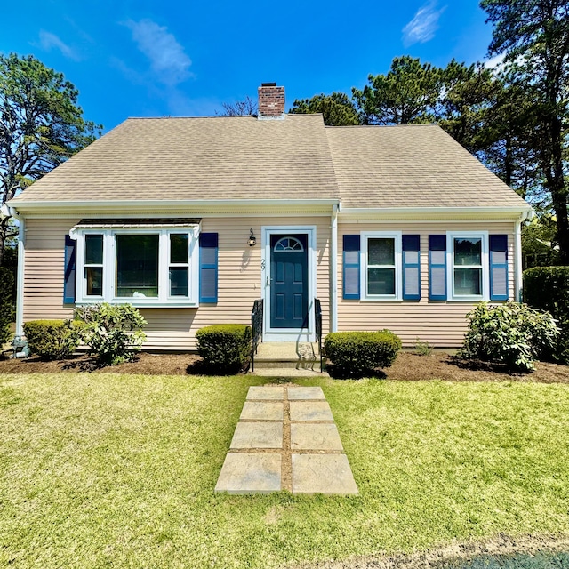 29 Lumberjack Trl, West Yarmouth, MA 02673 - view of front of home featuring a chimney, a front yard, and a shingled roof