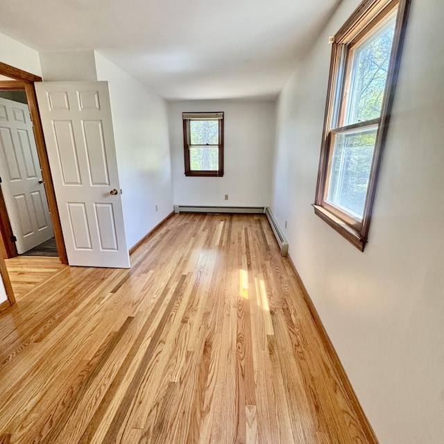 29 Lumberjack Trl, West Yarmouth, MA 02673 - unfurnished bedroom featuring light wood-type flooring, baseboard heating, and baseboards