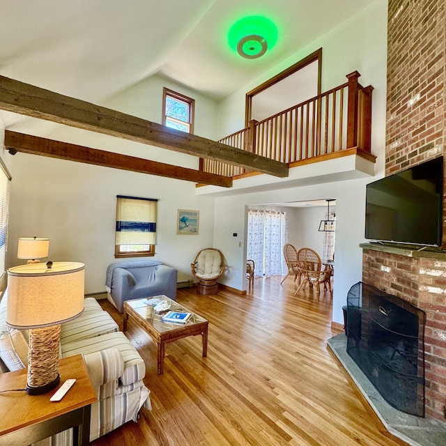 29 Lumberjack Trl, West Yarmouth, MA 02673 - living area featuring high vaulted ceiling, wood finished floors, a brick fireplace, and baseboards