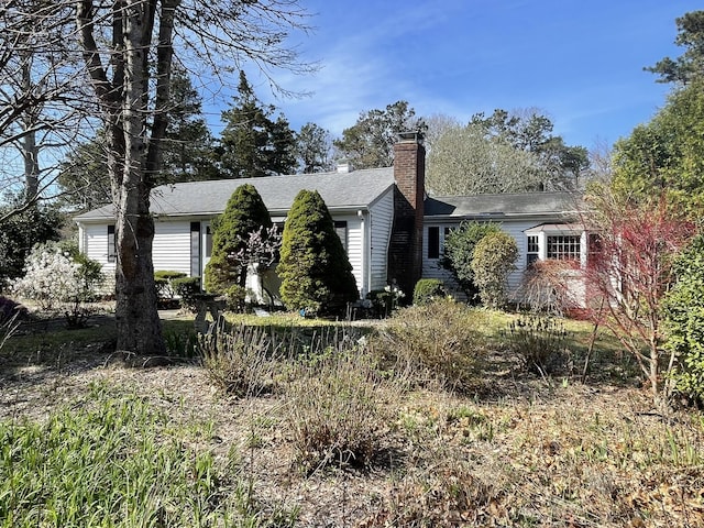view of property exterior featuring a chimney