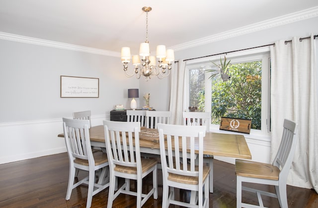 dining space with dark wood-style floors, baseboards, ornamental molding, and a notable chandelier