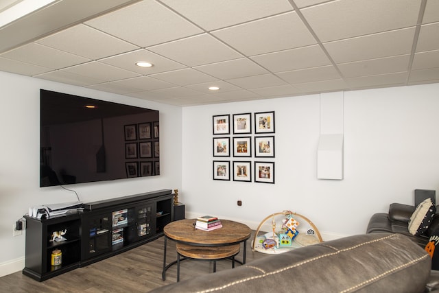 living room with a paneled ceiling, baseboards, wood finished floors, and recessed lighting