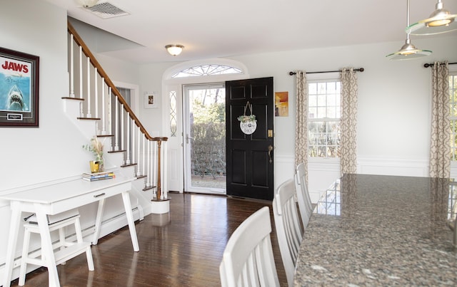 entrance foyer featuring stairs, visible vents, and dark wood-style flooring