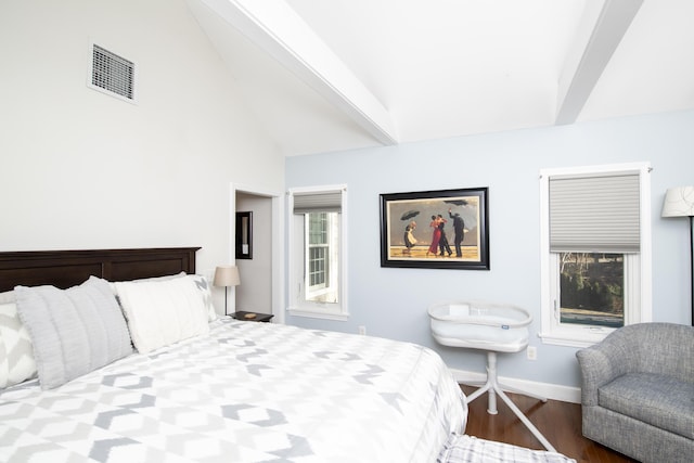 bedroom featuring vaulted ceiling with beams, baseboards, visible vents, and wood finished floors