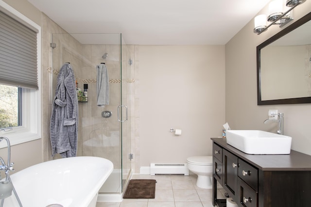 full bathroom with a freestanding tub, tile patterned flooring, toilet, baseboard heating, and a shower stall