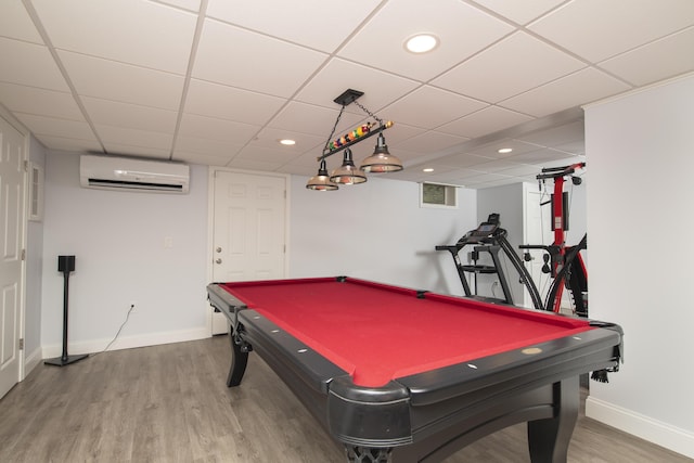 game room with a wall mounted AC, recessed lighting, wood finished floors, and baseboards