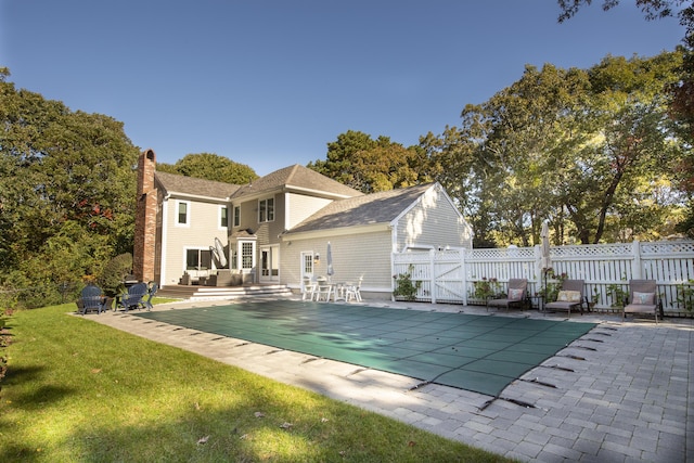 view of swimming pool featuring a lawn, a patio area, fence, and a fenced in pool