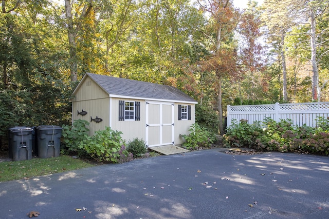 view of shed with fence