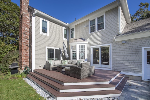 back of house with a deck, a chimney, an outdoor hangout area, and roof with shingles