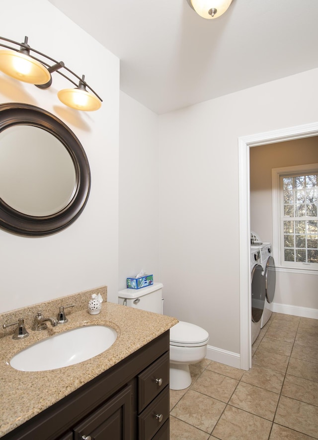 bathroom featuring baseboards, washer and clothes dryer, toilet, tile patterned floors, and vanity