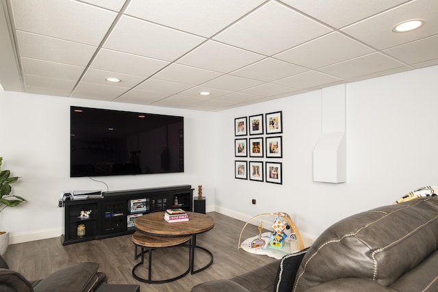 living area with a paneled ceiling, baseboards, dark wood-style flooring, and recessed lighting