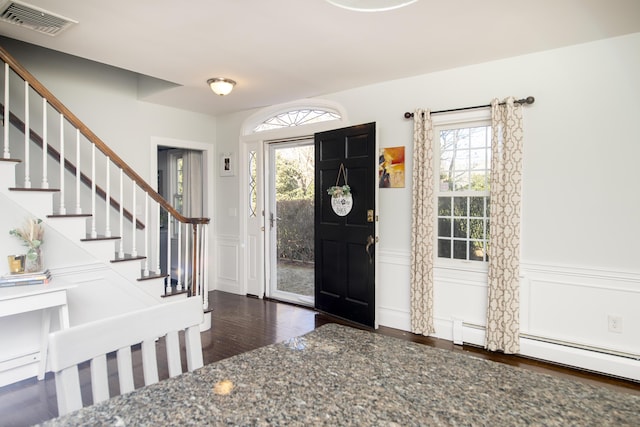 entrance foyer featuring stairs, plenty of natural light, and visible vents