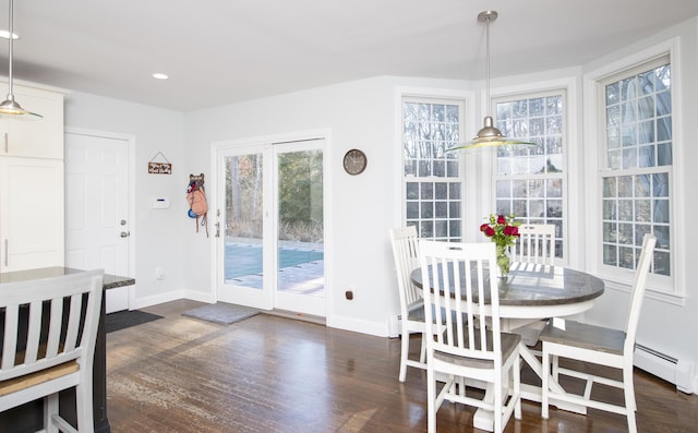 dining space with dark wood-type flooring, plenty of natural light, and baseboards