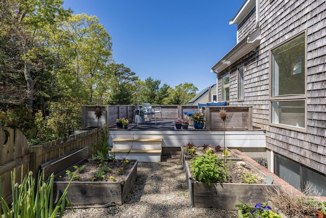 10 Westerly Dr, Bourne, MA 02532 - view of patio / terrace with a garden, a wooden deck, and fence