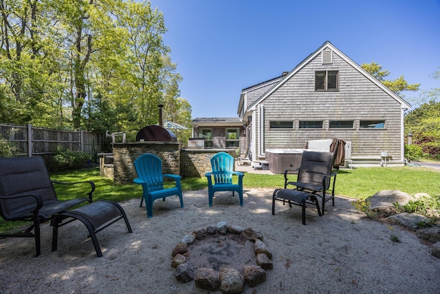 10 Westerly Dr, Bourne, MA 02532 - view of patio featuring a hot tub, exterior kitchen, and fence