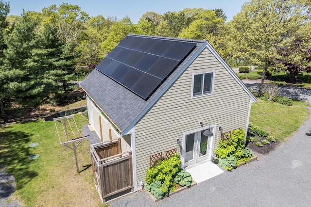 10 Westerly Dr, Bourne, MA 02532 - view of home's exterior with a lawn, solar panels, and french doors