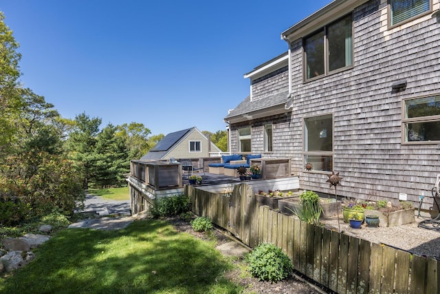 10 Westerly Dr, Bourne, MA 02532 - back of house featuring a vegetable garden, a lawn, and a wooden deck
