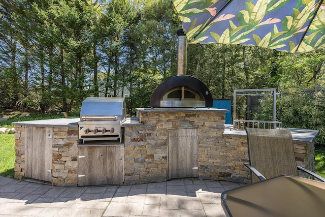 10 Westerly Dr, Bourne, MA 02532 - view of patio / terrace with exterior kitchen, a grill, and view of scattered trees