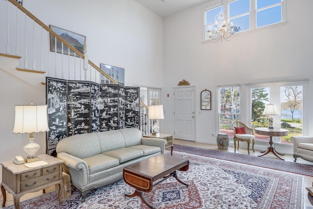 104 Seapine Rd, North Chatham, MA 02650 - living area featuring a towering ceiling, stairs, healthy amount of natural light, a chandelier, and baseboards