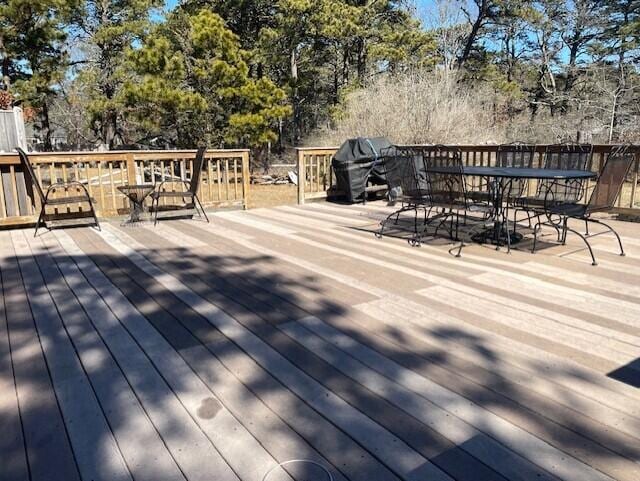 deck with area for grilling and outdoor dining area