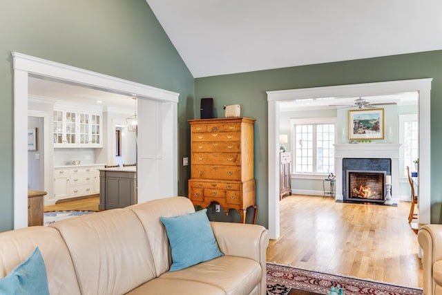 49 Atkins Rd, East Sandwich, MA 02537 - living room featuring a ceiling fan, light wood-style flooring, vaulted ceiling, and a fireplace with flush hearth