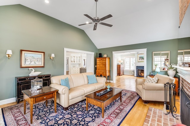 49 Atkins Rd, East Sandwich, MA 02537 - living room featuring ceiling fan, wood finished floors, a lit fireplace, and high vaulted ceiling