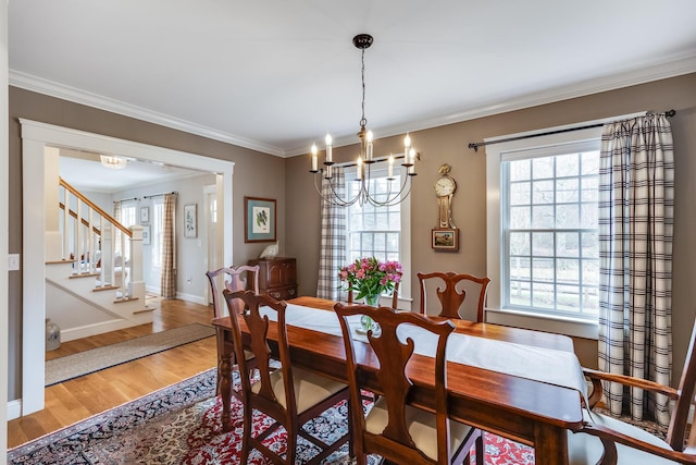 49 Atkins Rd, East Sandwich, MA 02537 - dining area featuring a chandelier, wood finished floors, plenty of natural light, crown molding, and stairway