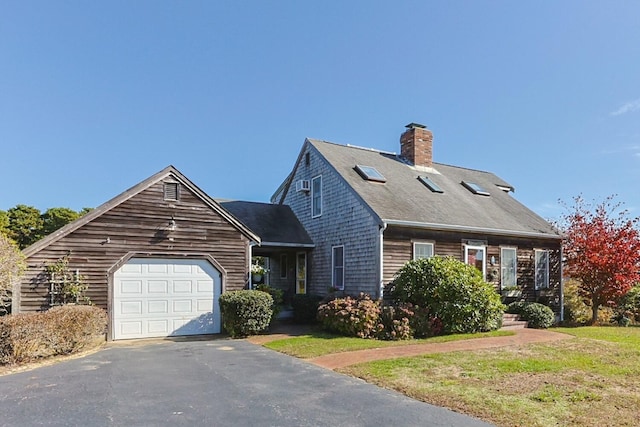 new england style home with a garage and a front yard