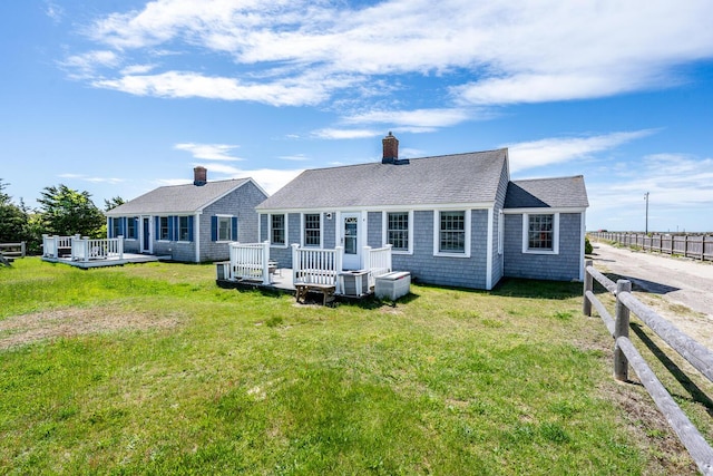 1006 Craigville Beach Rd Unit 4, Centerville, MA 02632 - back of property featuring a deck, a shingled roof, and a chimney