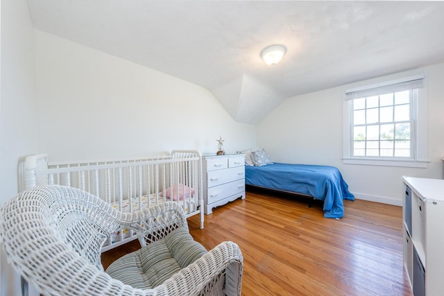 1006 Craigville Beach Rd Unit 4, Centerville, MA 02632 - bedroom with light wood-type flooring, lofted ceiling, and baseboards