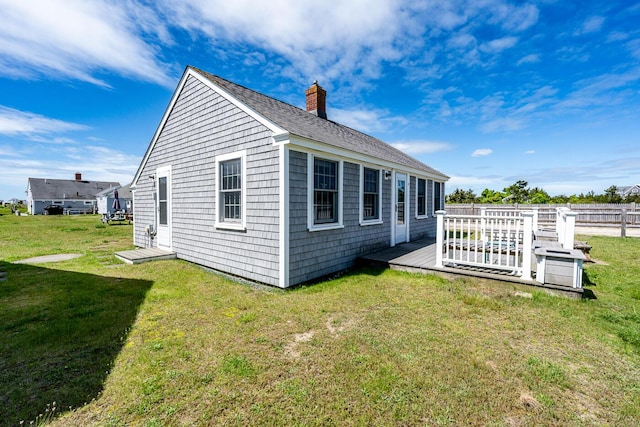 1006 Craigville Beach Rd Unit 4, Centerville, MA 02632 - rear view of property with a chimney, a lawn, a deck, and a shingled roof