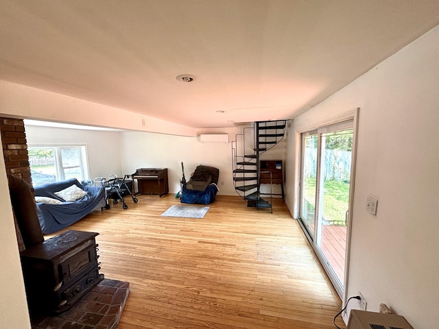 12 Amelia Way S, Yarmouth, MA 02664 - living room featuring plenty of natural light, a wall unit AC, wood finished floors, and stairway